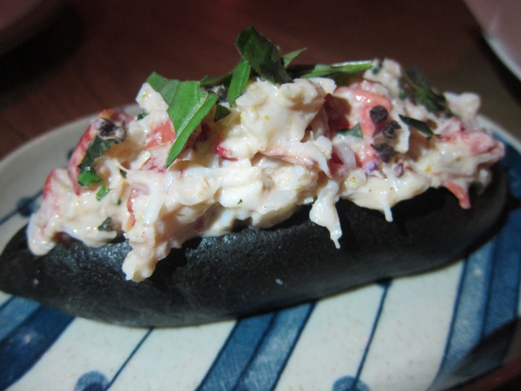 Lobster Roll with Green Curry and Thai Basil on a Charcoal-infused Bun