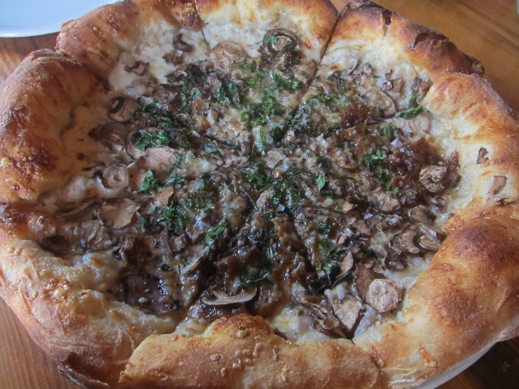 Shaved Mushroom Pizza with Gruyere, Melted Onions, Black Truffle, Torn Parsley, Rosemary and Thyme from Stella Barra Pizzeria