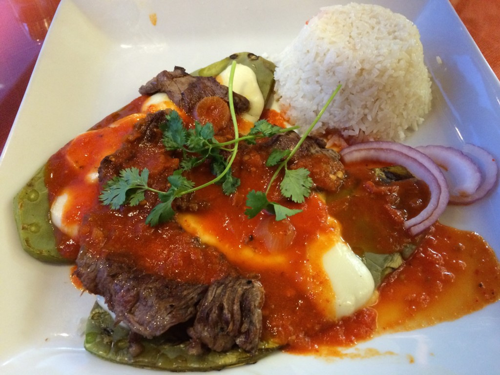 Conquista Plate with thin steak over grilled cactus, Oaxaca cheese and chile guajillo sauce